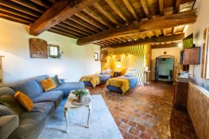 a living room with a couch and a table at Château beyrin in Traize