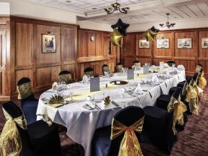 a conference room with a long table and chairs at Mercure Norwich Hotel in Norwich