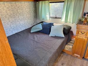 a bed with blue pillows in a bedroom at Kleine Auszeit in Schermbeck