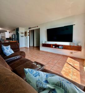 a living room with a large flat screen tv at Sea View Rooftop in Cabo Rojo