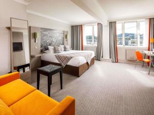 a hotel room with a bed and a couch at Mercure Inverness Hotel in Inverness +89 photos