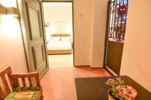 a dining room with a table and a bedroom at Evilion Suites in Xylokastro +30 photos