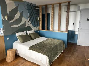 a bedroom with a bed with a blue wall at Hôtel Particulier Nontron - chambre d'hôtes et meublés de tourisme in Nontron +52 photos