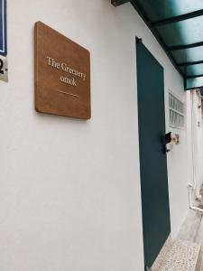 a sign on a wall next to a green door at The Greenery Omok in Seoul +28 photos