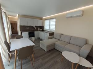 a living room with a couch and a table and chairs at Bianka & Blanka in Poľný Kesov