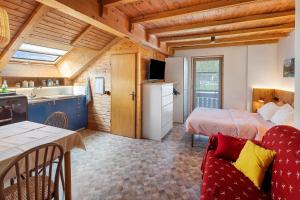 a room with two beds and a kitchen with a sink at Casa Morsich in Predazzo