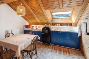 a kitchen with blue cabinets and a table and a sink at Casa Morsich in Predazzo