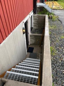 a set of stairs next to a red building at Wergelandsvegen 40B in Stjoerdal