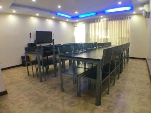 a conference room with a long table and chairs at Cindy Kelly Hotel in Olongapo