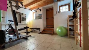 a gym with a treadmill and a green exercise ball at Ledro Nest in Ledro