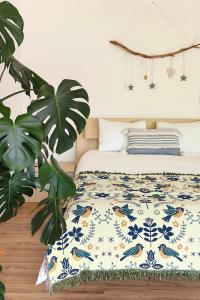 a bedroom with a bed with a blue and white blanket at Villa Seashell in Prčanj