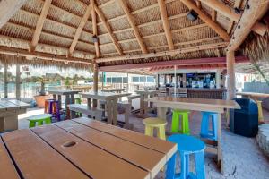 a restaurant with wooden tables and colorful stools at Daytona Beach Studio w/ Ocean View + Amenities! in Daytona Beach