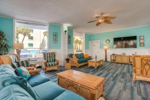 a living room with a blue couch and chairs at Daytona Beach Studio w/ Ocean View + Amenities! in Daytona Beach
