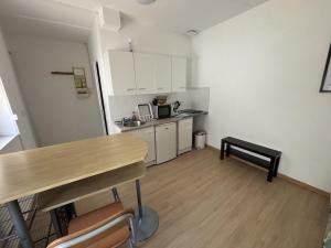 a small kitchen with a table and a counter top at Le Saint Vaast - Studio au centre d'Arras in Arras +2 photos
