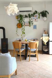 a table and chairs in a living room with a table at Villa Seashell in Prčanj