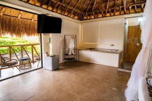a room with a kitchen and a balcony with a table at Hotel Alto de Pajas Boutique by H&R in Villeta