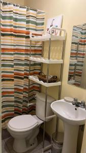 a bathroom with a toilet and a sink at Casa Shelter in Chimbote