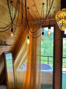 a bathroom with a shower curtain and a tub at cottage sunrise house merisi in Merisi