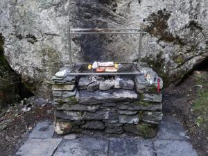 a grill sitting on top of a pile of rocks at Rustico La Stalla di Adele in Cevio