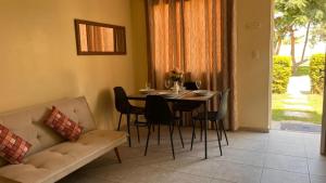 a living room with a table and chairs and a couch at Casa Shelter in Chimbote