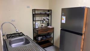 a kitchen with a stainless steel refrigerator and a sink at Casa Shelter in Chimbote