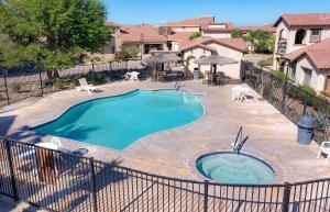 a swimming pool in a yard with chairs and tables at Condo 40-4 El Dorado Ranch in San Felipe