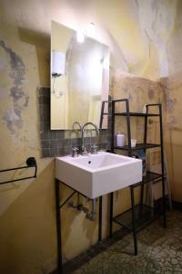 a bathroom with a white sink and a mirror at Loft in cisterna romana in Amelia +21 photos