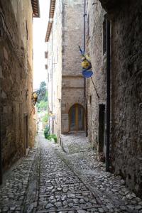 an alley with flags on the side of a building at Loft in cisterna romana in Amelia