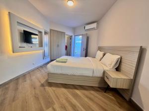 a bedroom with a bed and a television in it at Hurghada Porto View in Hurghada