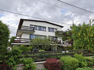 a white house with a lot of plants at Relaks XXL in Kartuzy
