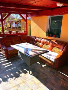 a leather couch and a table in a patio at Casa Denisa in Sulina