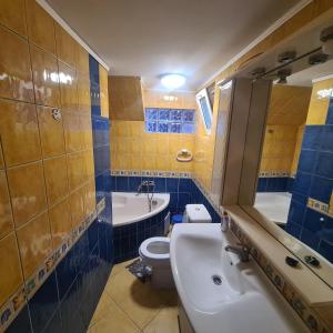 a bathroom with a sink and a toilet and a tub at CASA Ysy SUD in Eforie Sud
