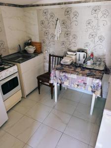 a small kitchen with a table and a stove at Casa Denisa in Sulina