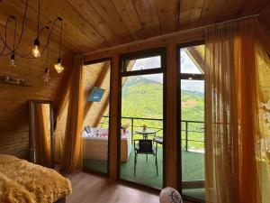 a bedroom with a large window with a view of a mountain at cottage sunrise house merisi in Merisi +149 photos