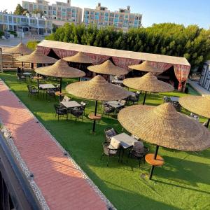 a group of tables and chairs with umbrellas at Hurghada Porto View in Hurghada