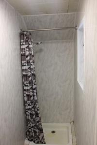 a shower with a shower curtain in a bathroom at Half Moon Inn in Llanthony +16 photos