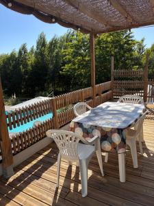a table and chairs on a wooden deck at Lbkn in Toulouse