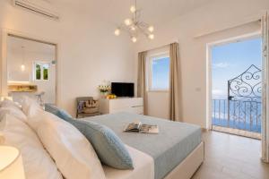 a bedroom with a bed and a view of the ocean at Amore Rentals - Villa Anna in Positano