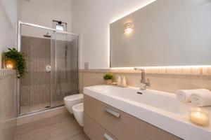 a bathroom with a sink and a shower and a toilet at Amore Rentals - Villa Anna in Positano +19 photos