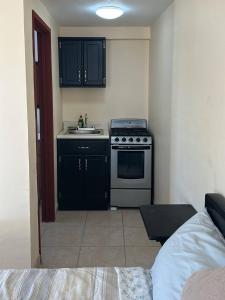 a small kitchen with a sink and a stove at Rancho Percebu Beach Studio 5 in San Felipe