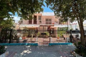 a black fence in front of a pink building at Casa Crespo in Cartagena de Indias