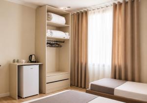 a bedroom with a bed and a window at OKEJ Hotel in Golem