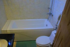 a bathroom with a white tub and a toilet at Burqito International Hotel in Āwasa