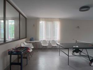 a living room with a ping pong table and chairs at Likhauri Guesthouse in Likhauri