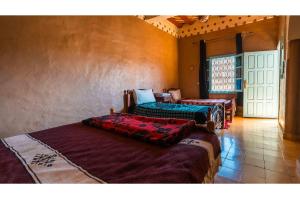 a room with three beds in a room at Maison Zouala in Zouala