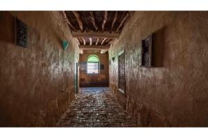 an empty hallway in an old building with a window at Maison Zouala in Zouala