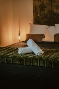 a roll of toilet paper sitting on top of a bed at O coeur de l'ouest Bungalow Maloya in Le Bois de Nèfles +31 photos