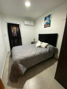 a bedroom with a bed in a room with a window at El Quincho in Lobos +55 photos