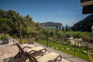 a patio with chairs and a view of the ocean at Elysium Villa in Kaluđerac