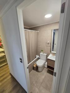 a bathroom with a toilet and a sink at Baquedano in Coquimbo